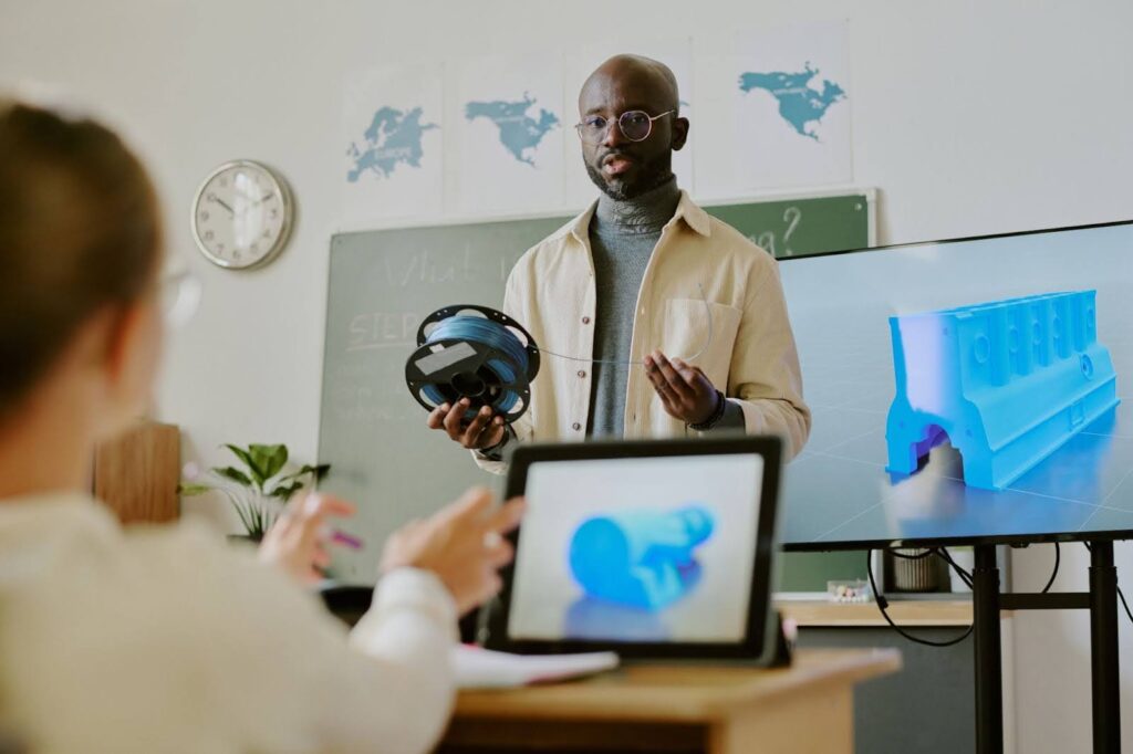 A teacher presents virtual reality technology to students in a classroom.