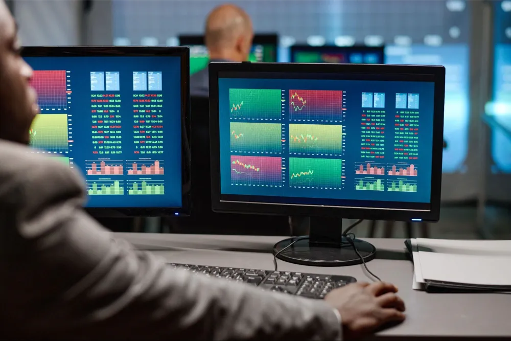 Analyst reviewing data charts and graphs on a digital dashboard.