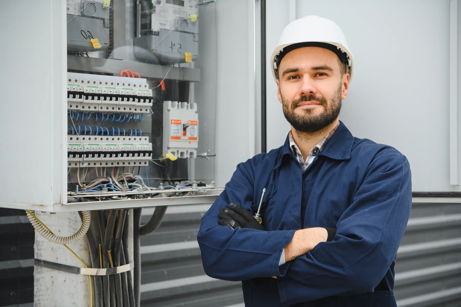 Electrician standing in front of an electrical panel