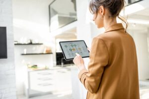 Woman using a smart device in her home.