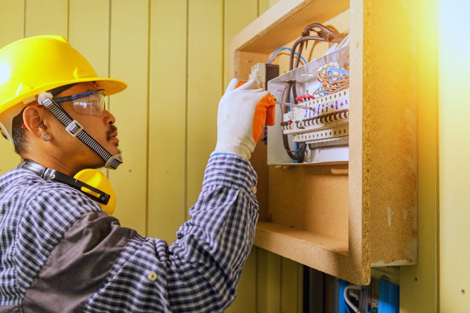 Professional electrician testing relay connections and household electrical wiring.